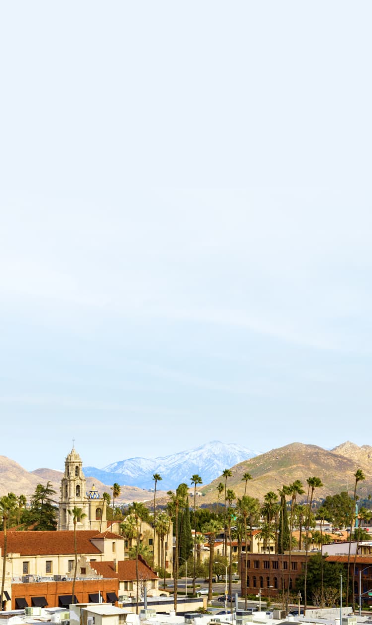 A city in southern California with mountains in the distance