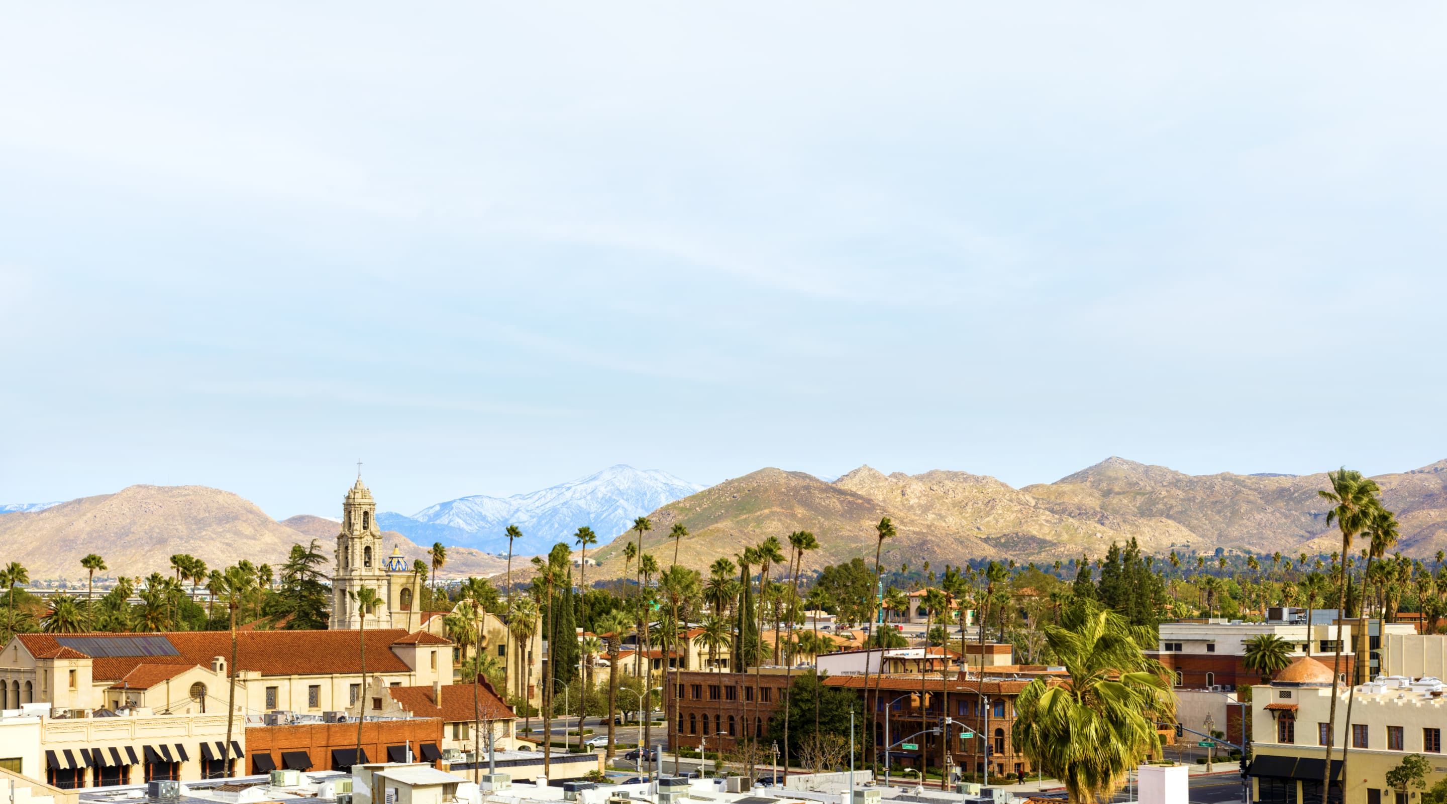 A city in southern California with mountains in the distance